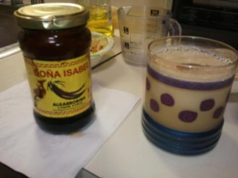 Drink with jar of Algarrobina Syrup from Peru